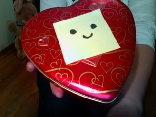 A little red tin box with a smiley face on it